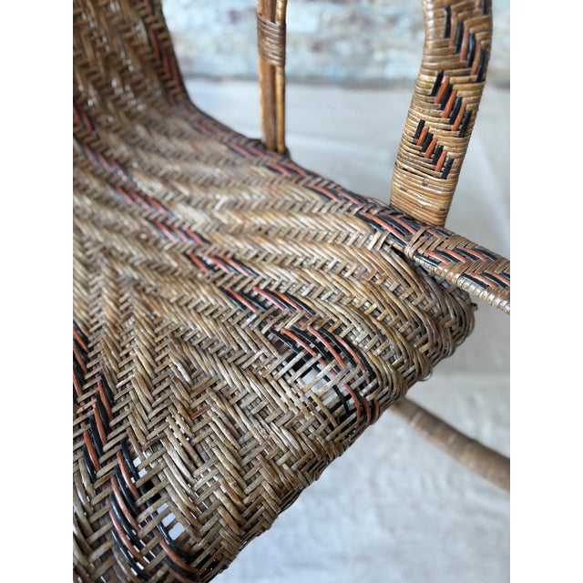 Bring classic charm and sculptural elegance to your home with this beautiful vintage wicker rocking chair. This piece...
