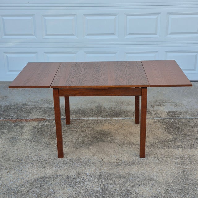 This is a useful and stylish space saving dining table. The square table measures 35.5" square when folded down. Two...