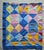 A cheerfully colored mid-century hand-stitched patchwork quilt with solid triangular pieces giving it a bright graphic...
