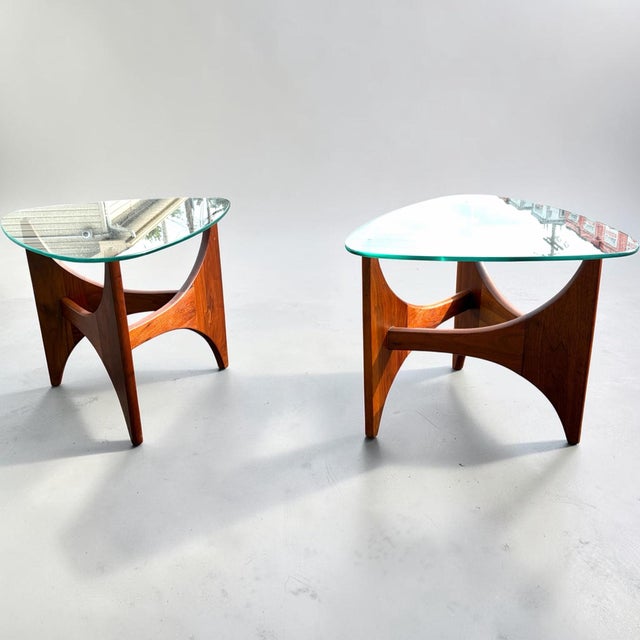 A beautiful pair of “guitar pick” triangular form glass top side/lamp tables. Designed by Adrienne Pearsall for Craft...