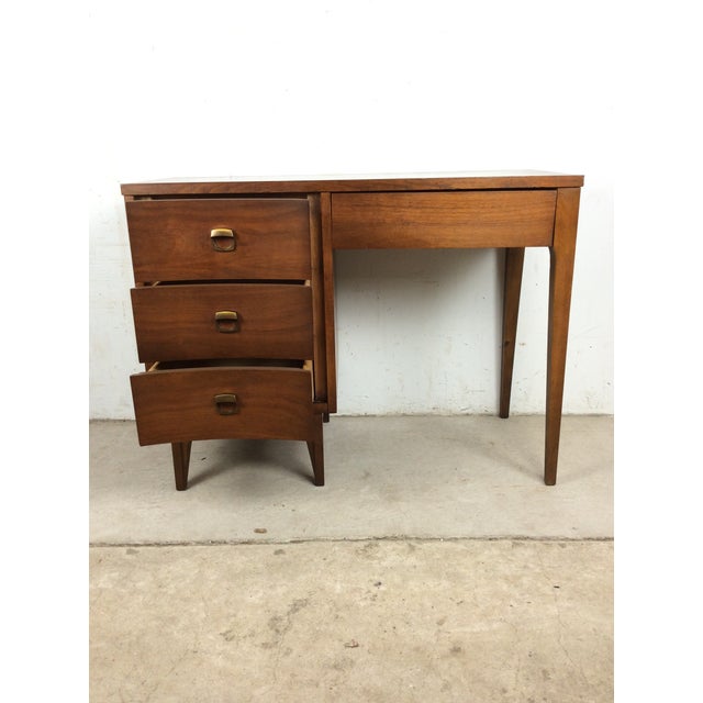 This mid century modern writing desk features hardwood construction, walnut veneer with original finish, four dovetailed...