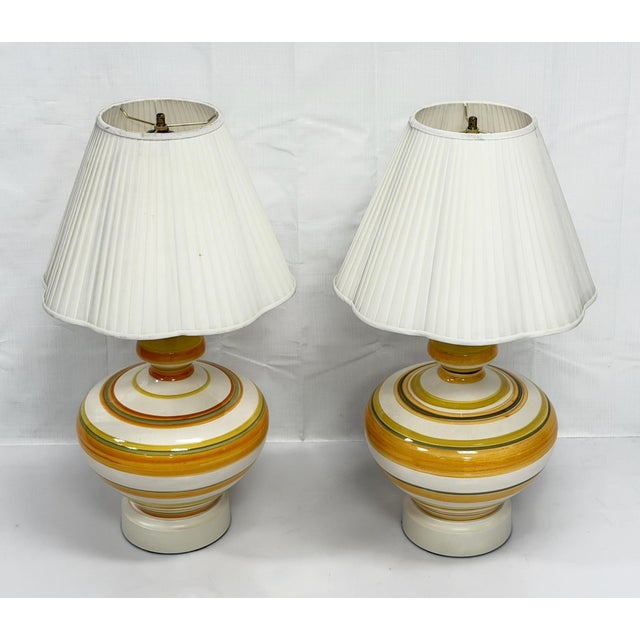 A striking pair of vintage 1960s ceramic table lamps, offered through Remains Lighting as part of their curated vintage...