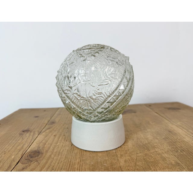 Vintage industrial ceiling or wall light made in former Czechoslovakia during the 1970s. It features a white porcelain...