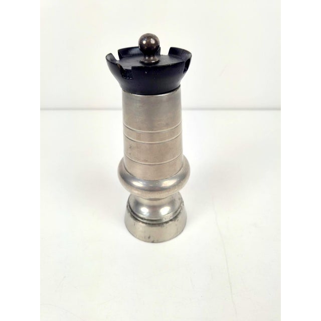 This is a vintage French pepper mill made of pewter and black wood, designed in the shape of a chess Tower