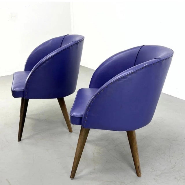 A fantastic pair of Danish Modern Purple Upholstered Barrel Tub Chairs. Pair vintage vinyl purple barrel chairs. Studded...