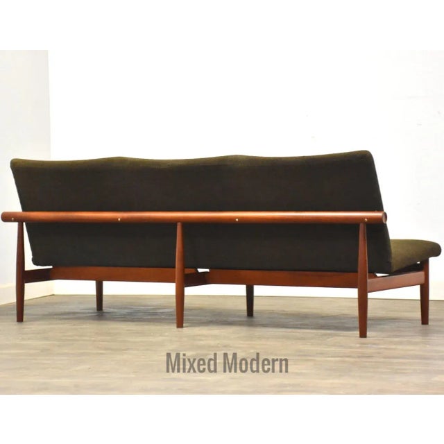 A mid century modern original solid teak three seater green sofa designed by Finn Juhl for France and Son. Professionally...
