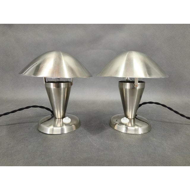 A refined pair of bauhaus table lamps from 1930s czechoslovakia. Executed in chrome plated metal, these lamps feature...