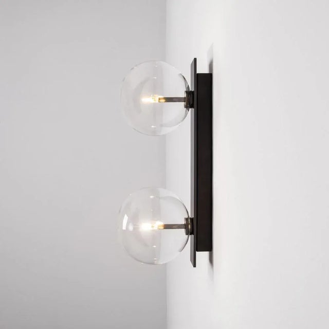Oslo dual wall sconce by schwung dimensions: w 15 x d 19 x h 40 cm materials: black gunmetal, hand blown glass globes...