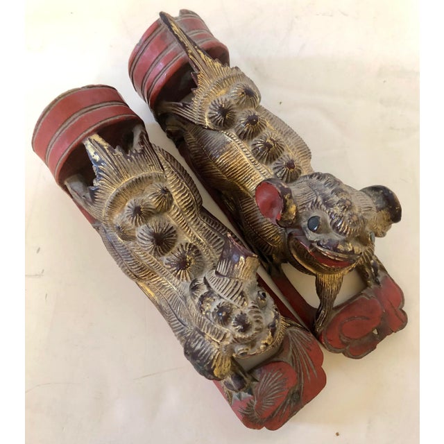 Charming pair of fu (foo) dog giltwood fragments are fashioned to hang on a wall but just as charming laying on a table....
