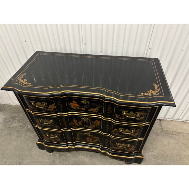 Offered is a chinoiserie style chest with hand painted details and three smooth gliding drawers.