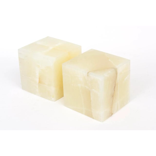 This pair of large onyx cube bookends, small pedestals or displays for sculpture or objects are variegated colors of...