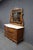 Pulaski Furniture Victorian Revival oak dresser with attached carved mirror and faux marble top. The dresser features...