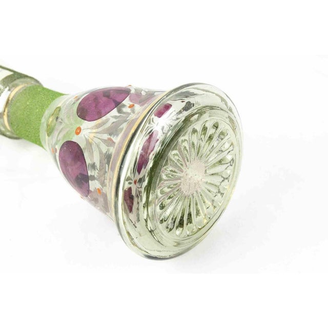 This glass pitcher is an original glass decorative object realized in the half of 20th century. A superb green colored...