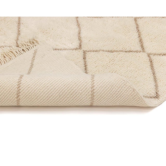 Elegant hand-knotted wool rug, featuring a lattice pattern in a harmonious blend of Ivory and Misty taupe, a versatile...