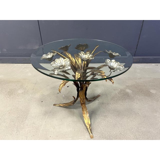 Charming metal flower coffee table or side table with a beveled glass top. Made in Italy, attributed to Hans Kögl....