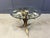 Charming metal flower coffee table or side table with a beveled glass top. Made in Italy, attributed to Hans Kögl....
