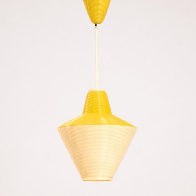Yellow cellulose pendant lamp by A.R.P and Rotaflex. Simple Rotaflex pendulum after a draft of Yasha Heifetz from the 60s....