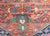 A wonderful early 20th century Persian Heriz rug with a primitive stylized floral pattern in the center listing amidst a...