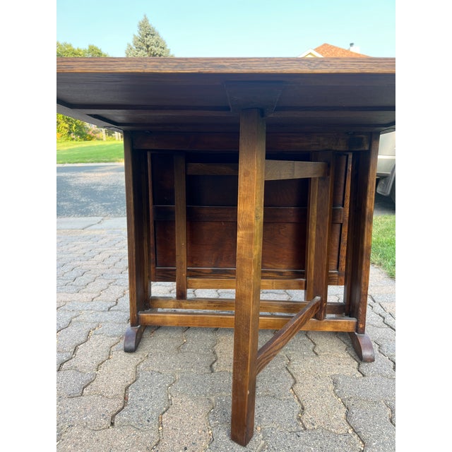 This is a beautiful dining table that folds for storage against a wall. It is solid wood with gate legs. In very nice...