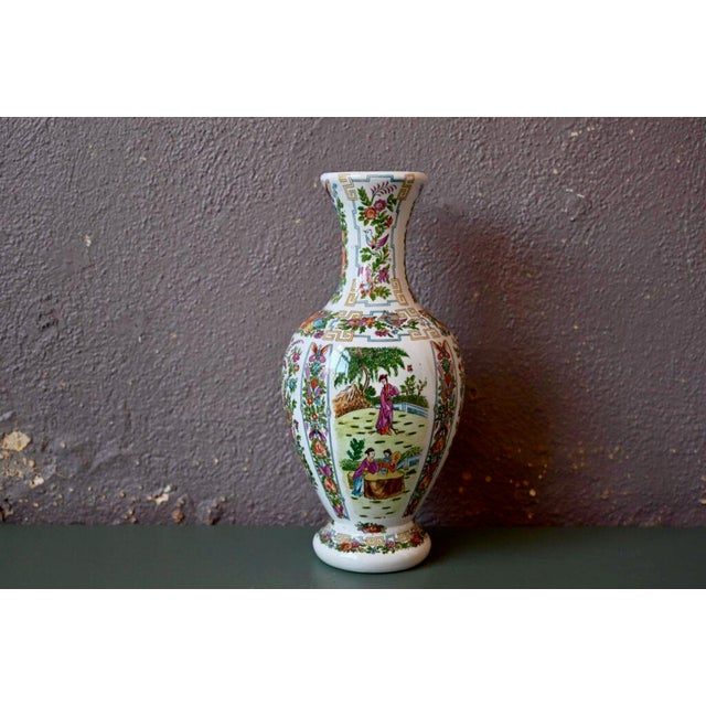 This large vase with a swollen and richly decorated body is a Chinese production. Floral decorations and geometric friezes...