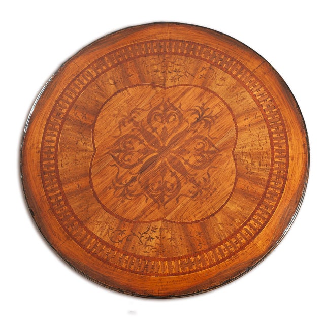 Handcrafted in Italy from solid walnut, this round dining table features an intricate inlaid top arranged in concentric...