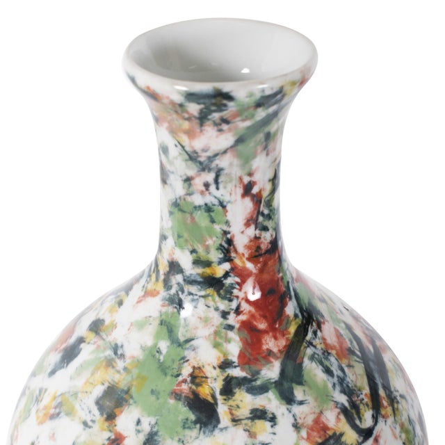Elevate your home decor with this exquisite white vase, each adorned with sporadic bursts of color in refreshing shades of...
