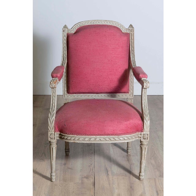 A French Louis XVI style painted wood armchair from the 19th century with carved décor including twisted rope motifs,...