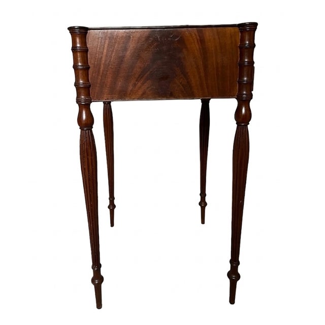 A refined late 19th century Sheraton Revival side table in mahogany, with a compact, versatile form. The rectangular top...