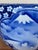 Large blue and white porcelain planter featuring a hand-painted mountain landscape motif reminiscent of Mount Fuji, framed...