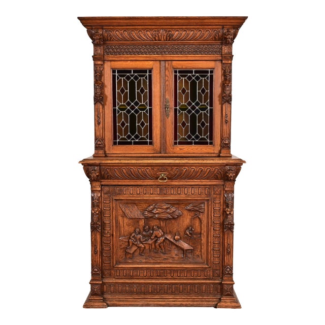 Antique French Renaissance Revival Carved Oak Breakfront Bookcase or Bar Cabinet With Stained Leaded Glass Doors, Circa 1890s For Sale