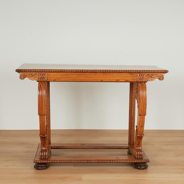 Refined 19th century William IV Anglo Indian console table handcrafted in teak wood featuring a top with a beaded edge and...