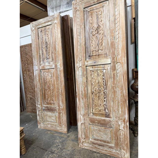 A stunning statement piece for any entryway, this antique carved wood door brings old-world charm with a soft, weathered...
