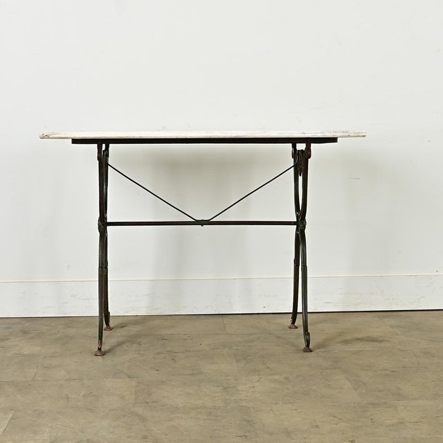 Dimensions: 28” H x 39 ½” W x 23 ⅝” D An original French brasserie table, circa 1890, with a removable white marble top on...