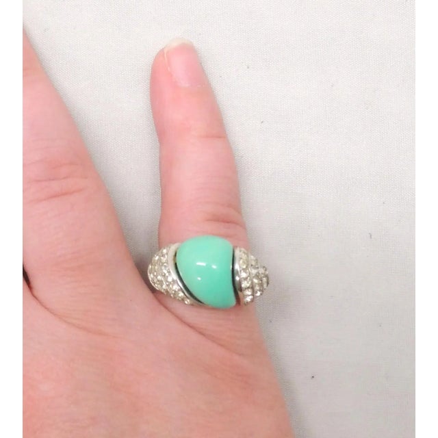 This is part of Chairish’s Costume Jewelry assortment. 1960s rhodium plates resin faux-turquoise center stone with pavé...