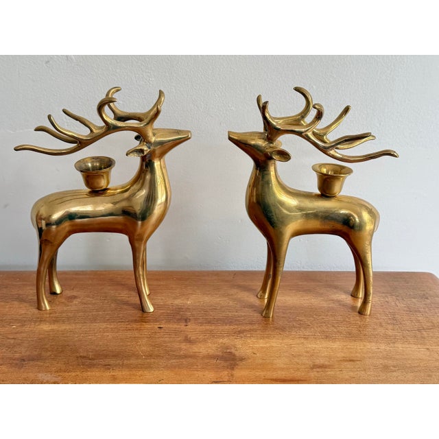 Late 20th century solid brass reindeer candlestick holder pair, appealing and shiny Christmas and winter decor. Please see...