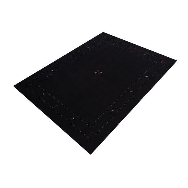 Make a bold statement in your living area with this exquisite contemporary Gabbeh wool rug. It is meticulously hand-...