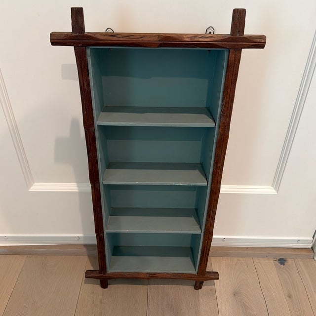 A wonderfully charming vintage wall shelf featuring a hand carved rustic twig style wooden frame surrounding a painted...