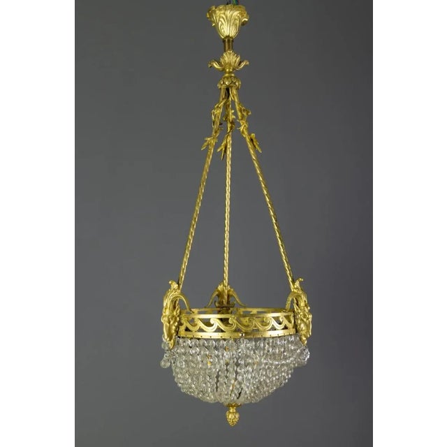 - The central lighting cluster is surrounded by beautiful beaded crystal garlands; - an elegant rim with three ram's...