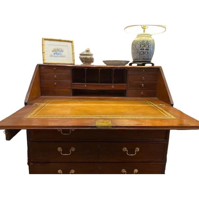 An exceptional 18th-century slant front desk in rich mahogany with authentic leather writing surface. This distinguished...