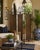 An elegant vintage three-panel folding room divider featuring a beautifully crafted wrought iron frame with decorative...