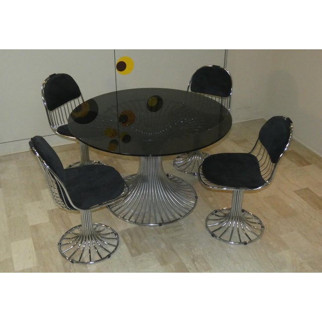 A splendid set of 4 chairs and a table, designed by gastone rinaldi and produced by rima in 1968. Each piece is crafted...