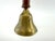 A vintage hand bell crafted with a warm turned wood handle and an engraved brass bell featuring hand-cut decorative...
