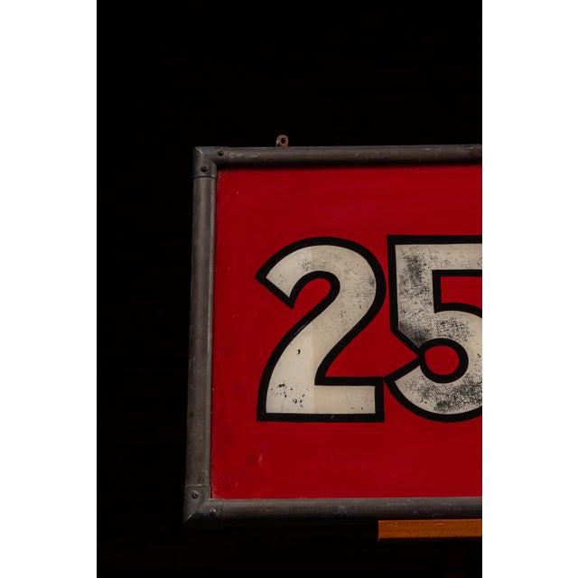 Reverse painted on glass (ROG) retail price sign featuring bold white numerals and lettering reading "25¢ to $1.00" set...