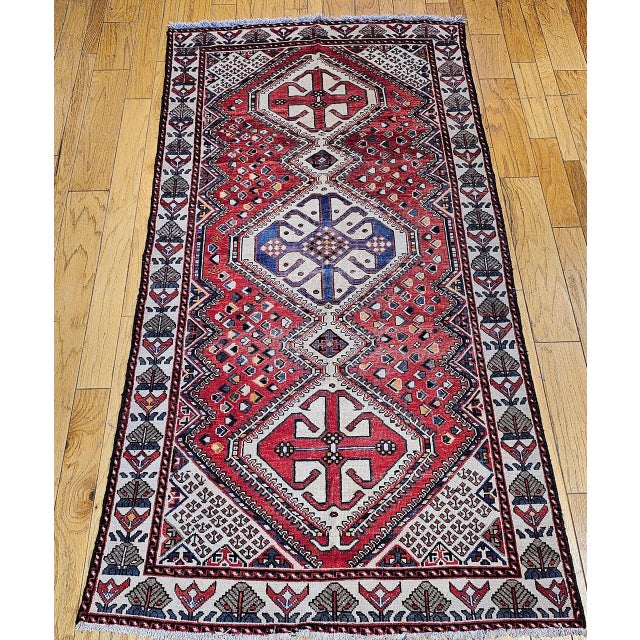 "This vintage Persian Shiraz area rug, hand-knotted circa the third quarter of the 20th century in the tribal weaving...