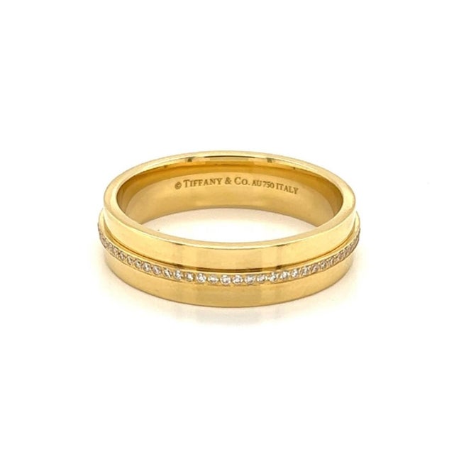 This elegant and authentic Tiffany & Co. ring from the T collection is crafted in solid 18k yellow gold with a fine...