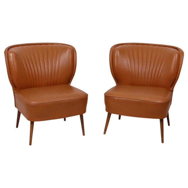 Vintage set of two "Expo 58" style cocktail chairs in cognac-colored faux leather (often referred to as *skai*), of...