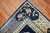 A rare 11-foot square early 20th-century shabby chic weather textured Chinese rug with a graphic floral Motif in denim...