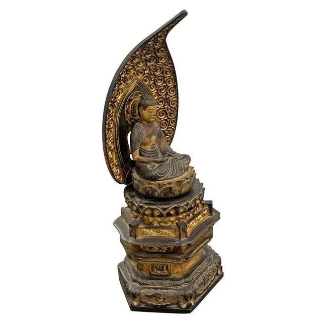 An incredible Edo Period Japanese gilt and lacquered carved wood shrine depicting a Bodhisattva with piercing glass eyes,...