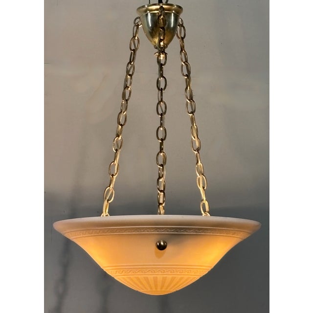 Art Deco period cast calcite glass bowl with brass hardware light fixture. Cleaned and re-wired, ready for installation....