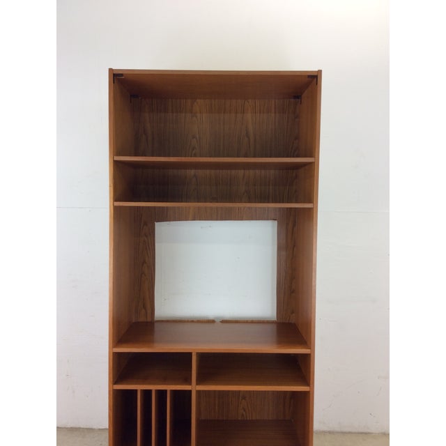 This Danish Modern teak shelving unit features pressed wood construction, teak veneer with original finish, two adjustable...